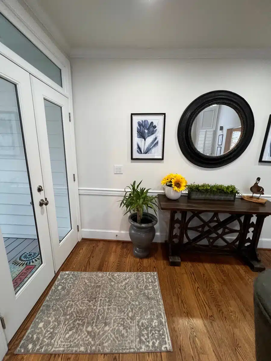 Clean restored entryway with hardwood floors and decor