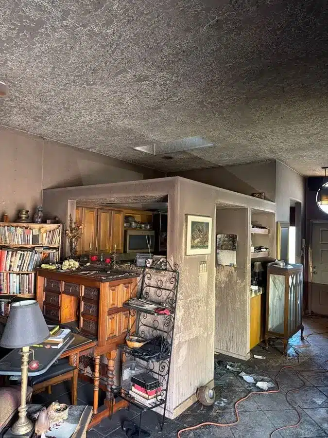 Fire-damaged living room before restoration