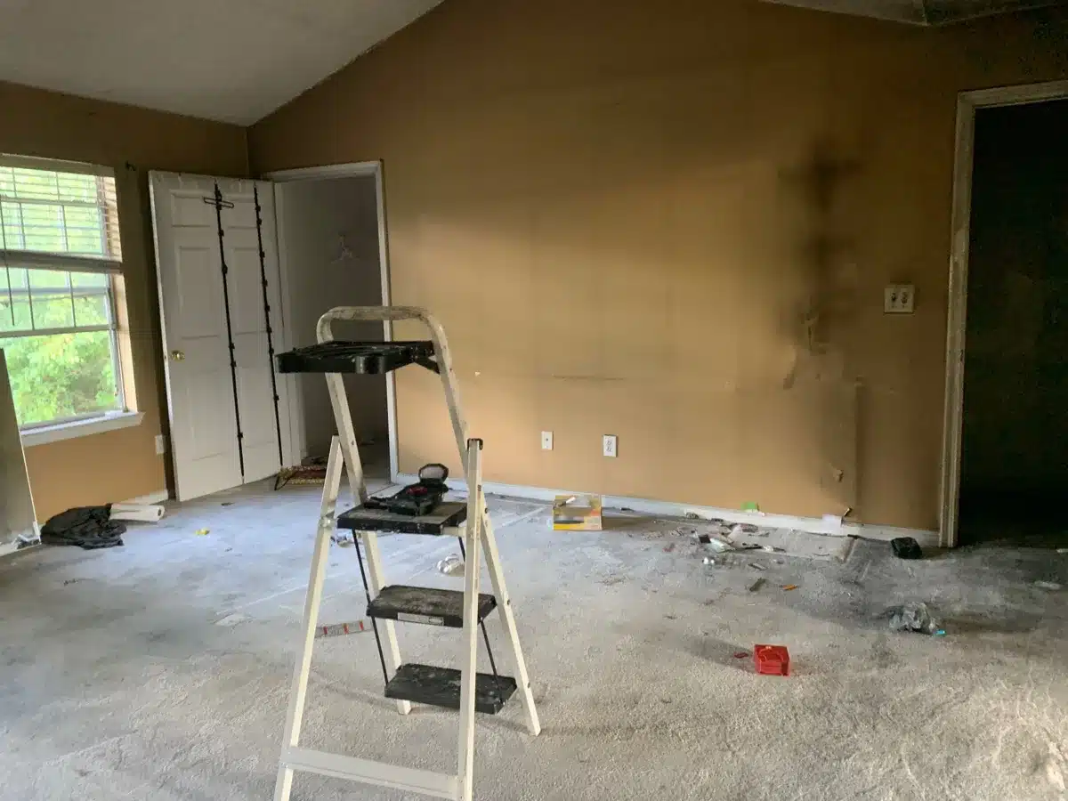 Room with smoke soot streaks on walls and ladder